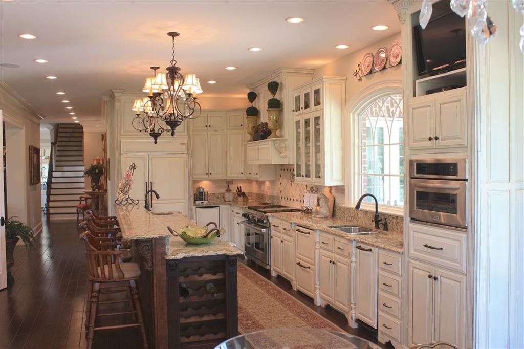 288 Irvin Road Stantonville, TN 38379 - Photo 7 of 25 Main Kitchen/Custom Antiqued Distressed Cabinetry with Beveled Granite Cultured Counter tops/Paneled Double Dishwasher/Warming Drawer/Wolfe Double Oven / Wolfe Dual Fuel Digital Range/Wine -Beverage Cooler/ SUBZERO refrigerator