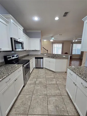 a kitchen with a stove a sink and a refrigerator