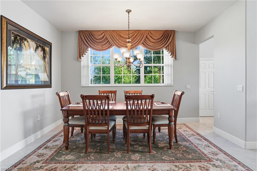 4620 Winged Foot Court, Unit 201 Naples, FL 34112 - Photo 11 of 44 Dining space with suspended lighting and baseboards