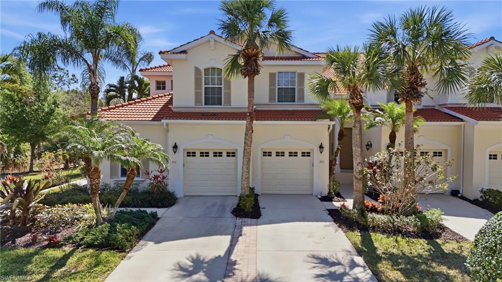 4620 Winged Foot Court, Unit 201 Naples, FL 34112 - Photo 2 of 44 Mediterranean / spanish-style home with concrete driveway, a garage, a tile roof, and stucco siding