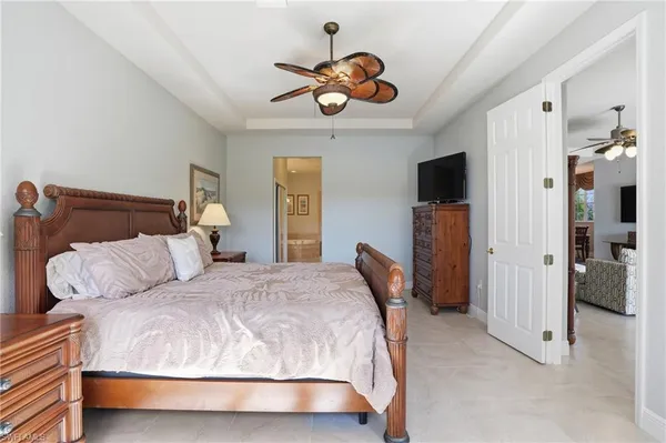 a bedroom with a bed and chandelier