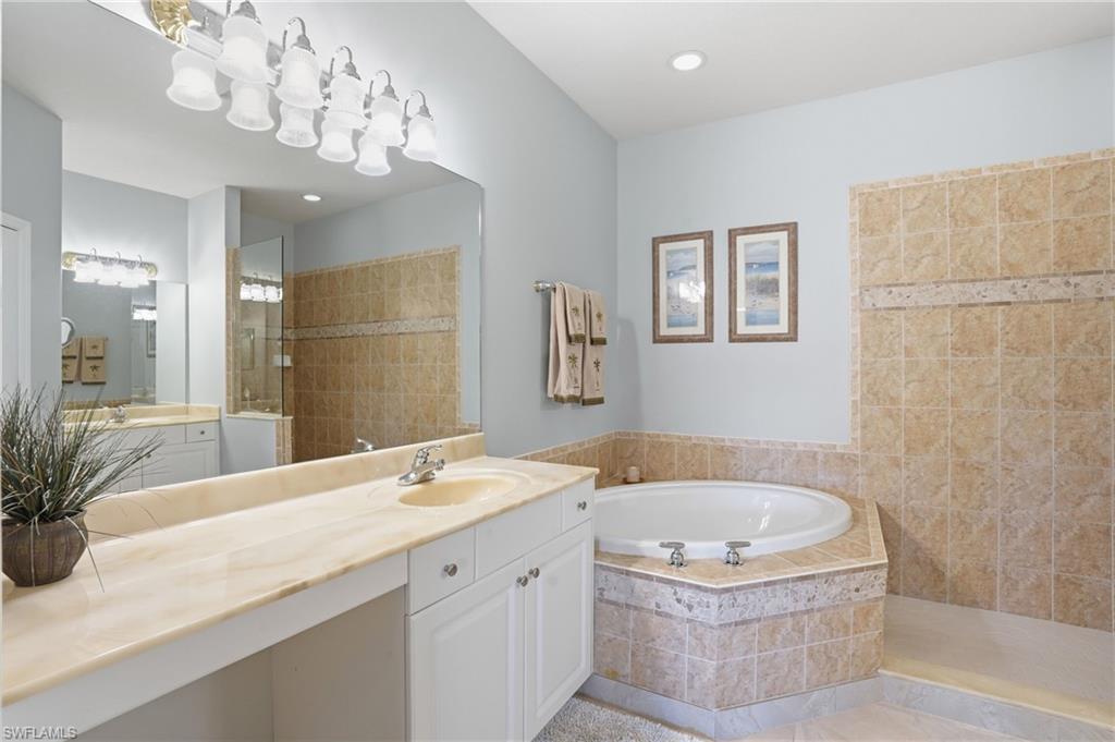 4620 Winged Foot Court, Unit 201 Naples, FL 34112 - Photo 24 of 44 Full bath featuring a walk in shower, vanity, and a bath