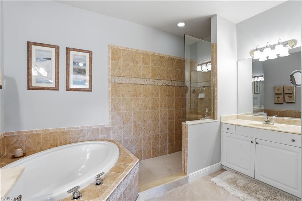 4620 Winged Foot Court, Unit 201 Naples, FL 34112 - Photo 25 of 44 Bathroom with vanity, walk in shower, and a bath