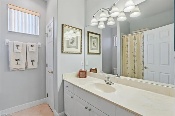 a bathroom with a sink vanity and a mirror