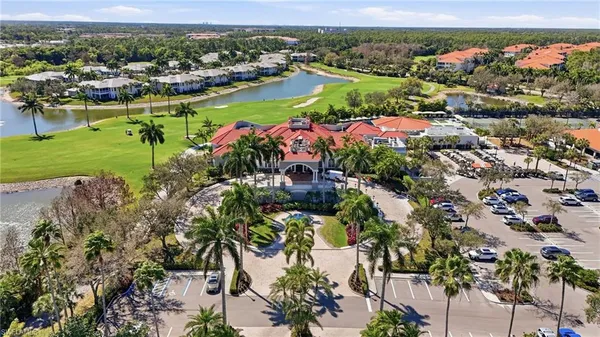 an aerial view of a city with lots of residential buildings ocean and mountain view in back