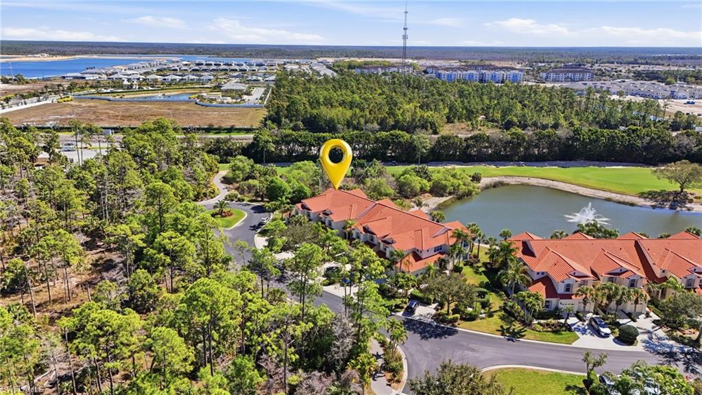 4620 Winged Foot Court, Unit 201 Naples, FL 34112 - Photo 7 of 44 Aerial view of residential area with a large body of water and a golf course