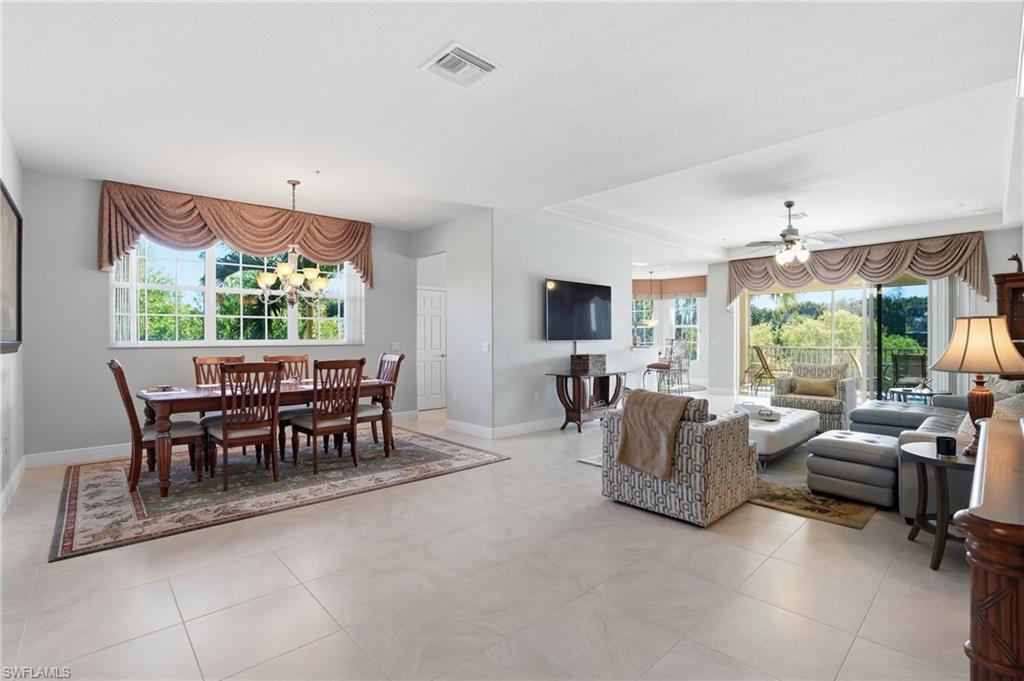 4620 Winged Foot Court, Unit 201 Naples, FL 34112 - Photo 9 of 44 Living area with healthy amount of natural light, ceiling fan, and a chandelier