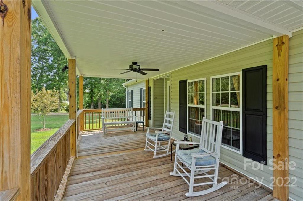 1158 Turkey Creek Ridge Road York, SC 29745 - Photo 2 of 13 a balcony with chairs and wooden floor