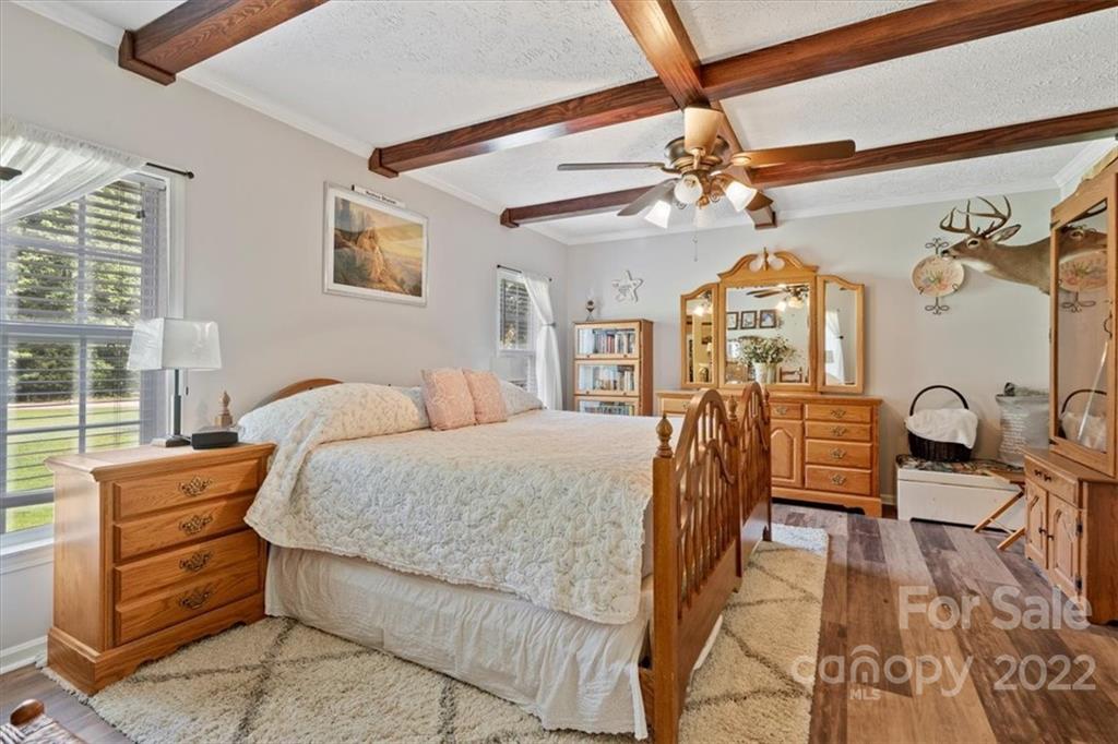 1158 Turkey Creek Ridge Road York, SC 29745 - Photo 5 of 13 a bedroom with a bed a chandelier and dresser