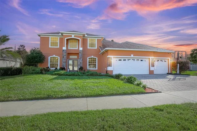 a front view of a house with a yard and garage