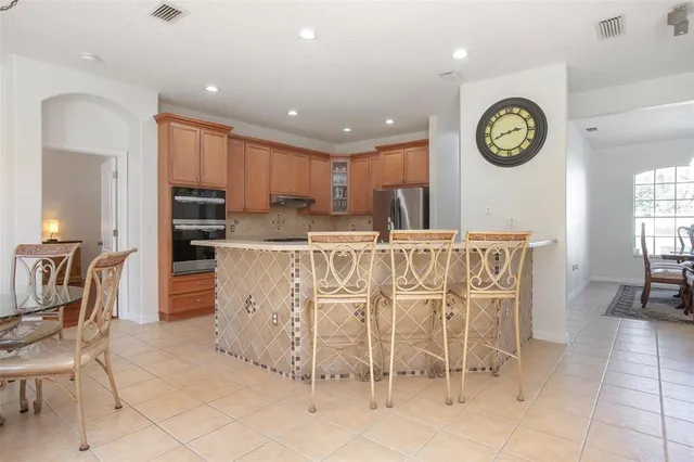 a kitchen with stainless steel appliances granite countertop a sink and dishwasher a stove top oven with wooden floor
