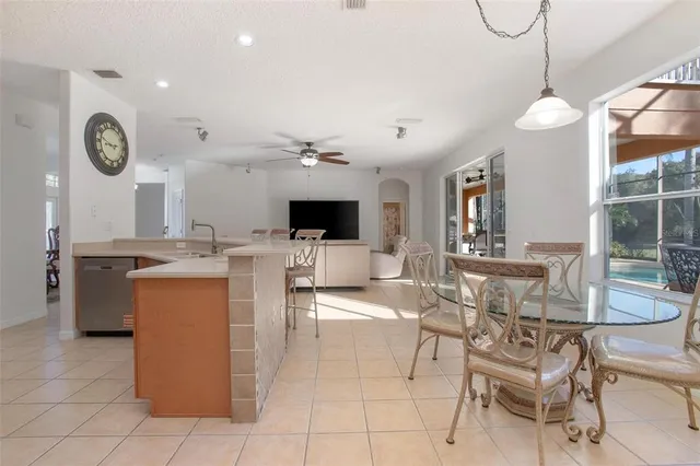 a large kitchen with stainless steel appliances granite countertop a large stove top oven a sink and dishwasher