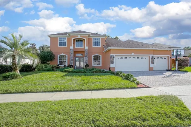a front view of a house with a garden and plants