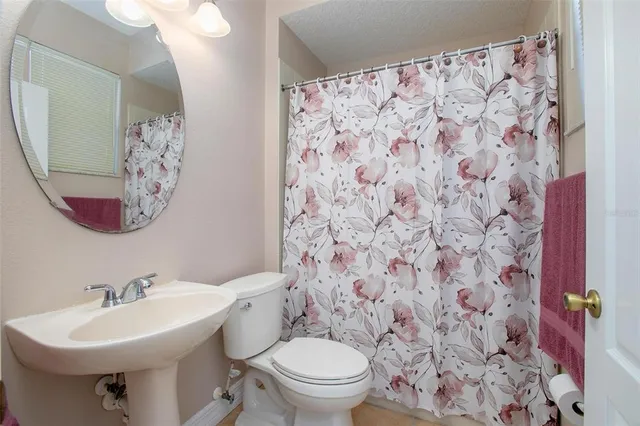 a spacious bedroom with a bed and wooden floor