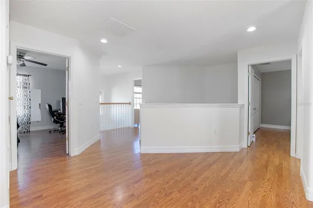 a room with pool table and windows
