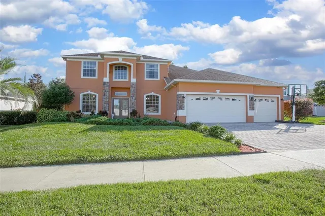 a front view of a house with a yard and garage