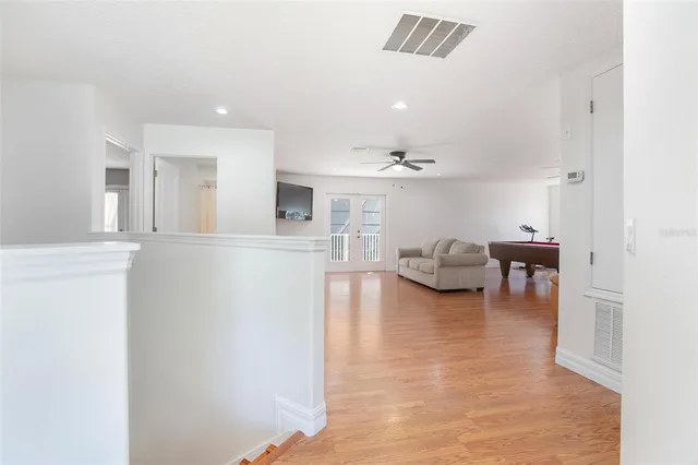 a bedroom with a large bed and a ceiling fan