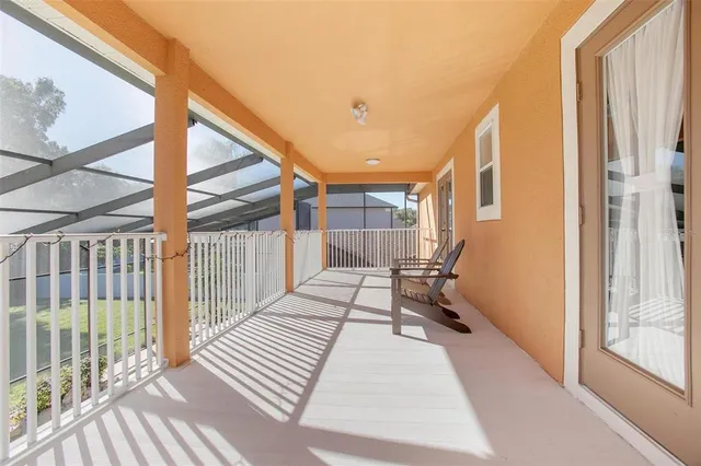 a view of a room with wooden floor and a large window