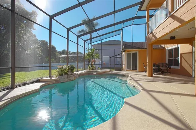 a view of a field with a tree in the background
