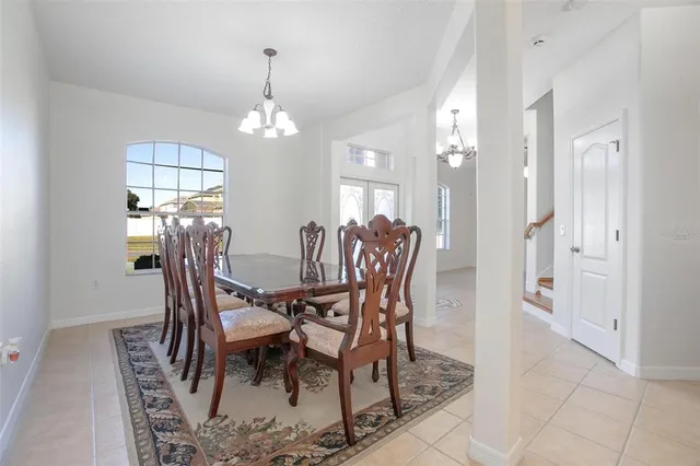 a view of a livingroom with furniture and a chandelier fan