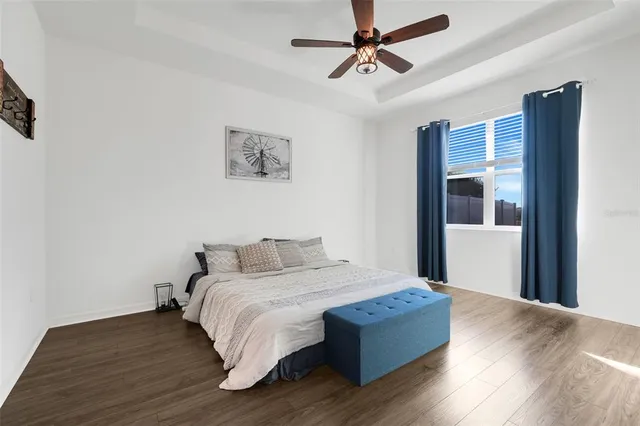 a room with a bed and wooden floor