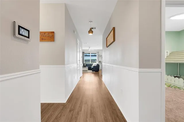 a view of a hallway with wooden floor and staircase