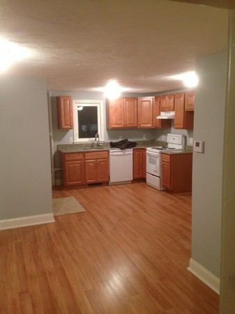 50 Cohasset Road Wareham, MA 02532 - Photo 6 of 11 a large kitchen with kitchen island a sink dishwasher a stove and a refrigerator with wooden floor