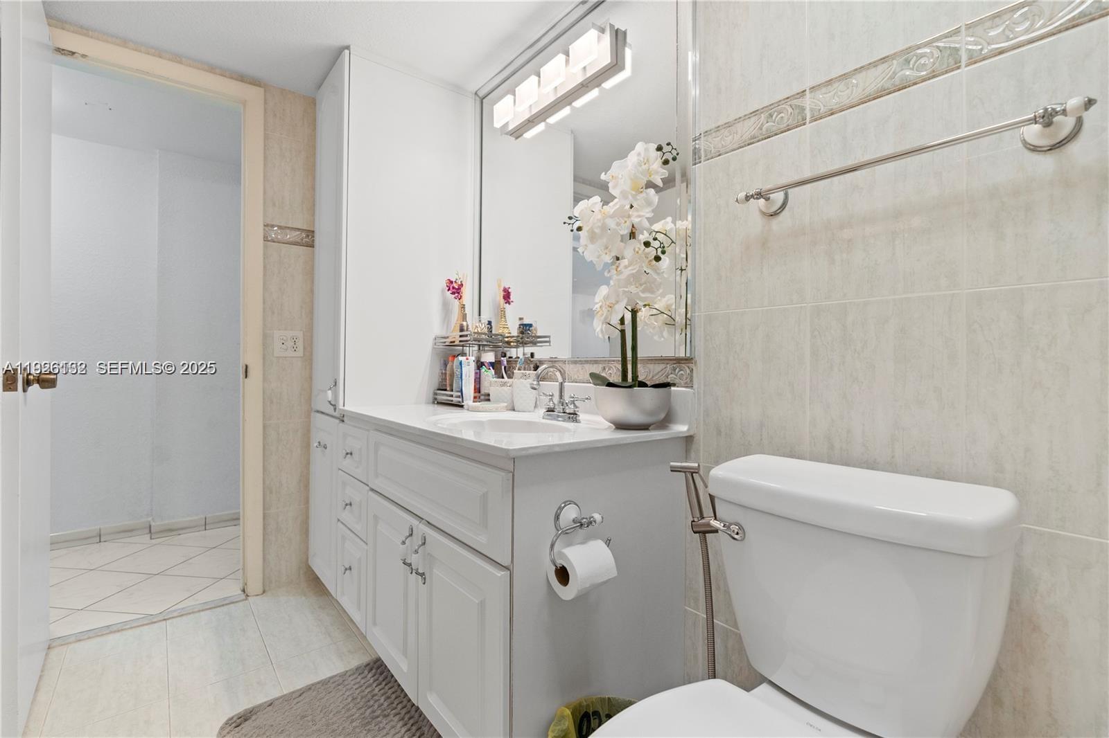 1810 West 56th Street, Unit 3223 Hialeah, FL 33012 - Photo 11 of 19 a bathroom with a sink a toilet and shower