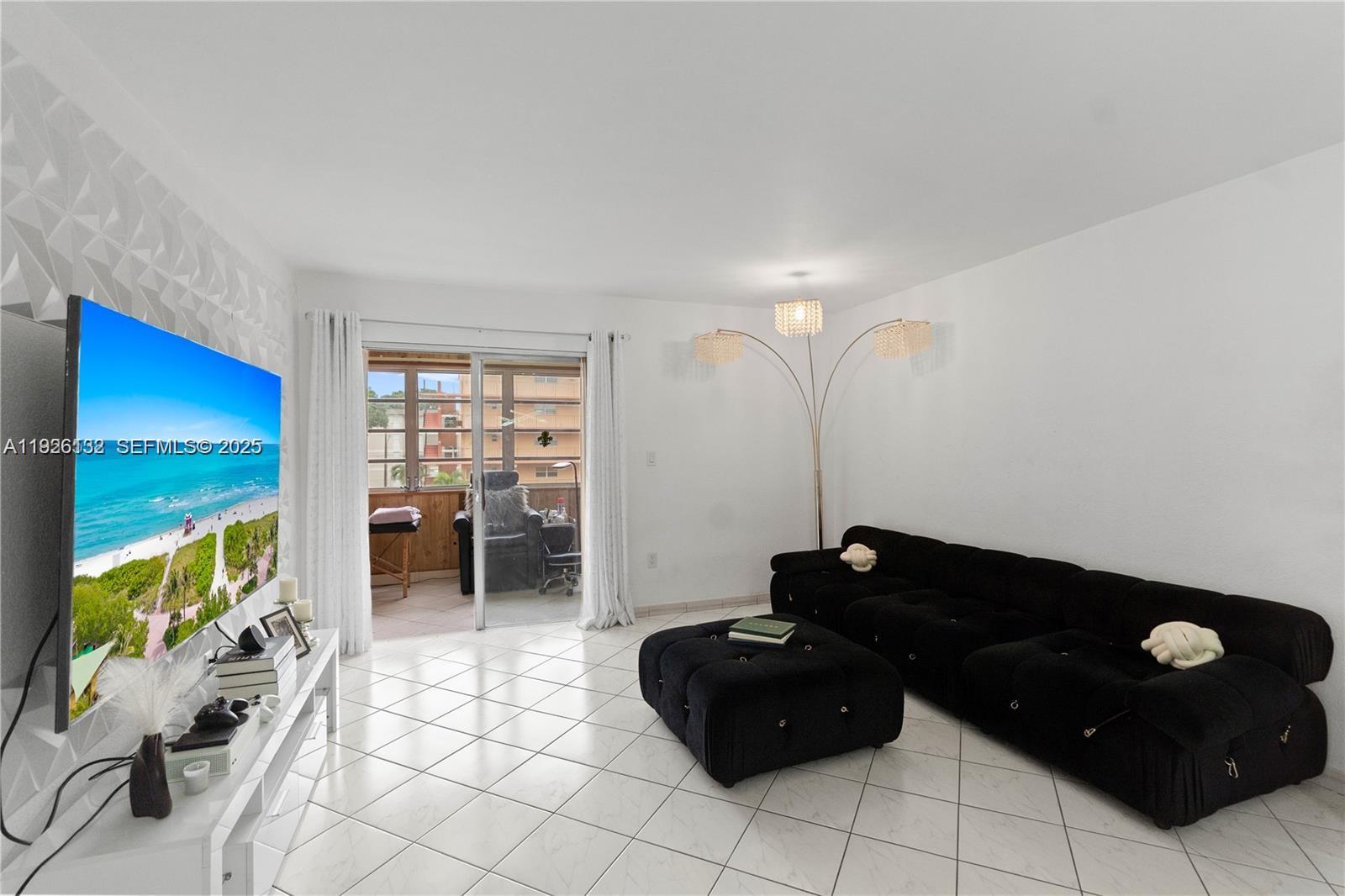 1810 West 56th Street, Unit 3223 Hialeah, FL 33012 - Photo 3 of 19 a living room with furniture and a flat screen tv