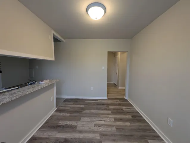 a view of an empty room and wooden floor