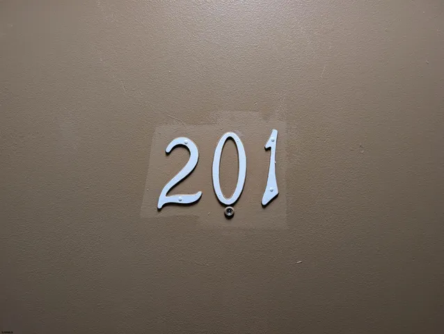a view of hallway with closet and wooden floor