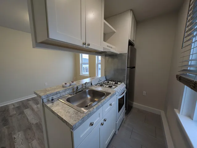 a kitchen with stainless steel appliances granite countertop a stove and a refrigerator