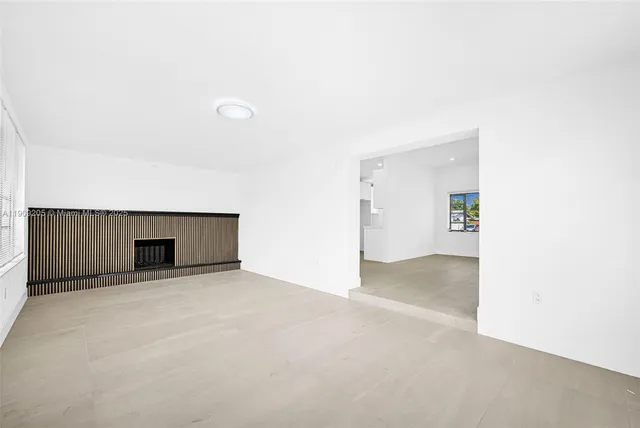 a view of an empty room with a fireplace