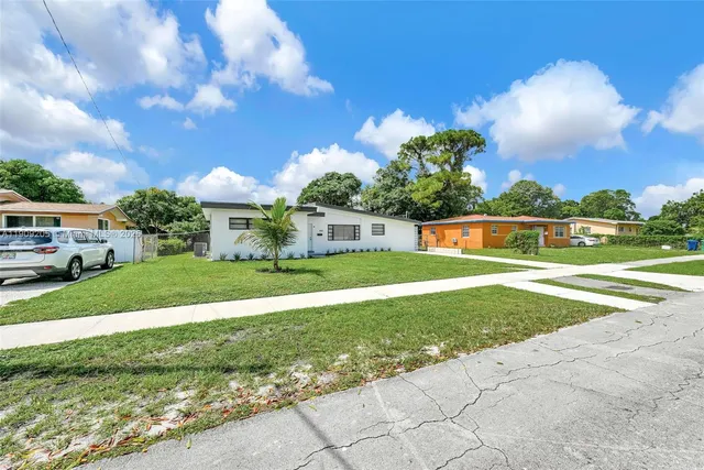 a front view of house with yard and green space