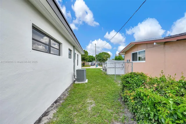 a view of house with backyard