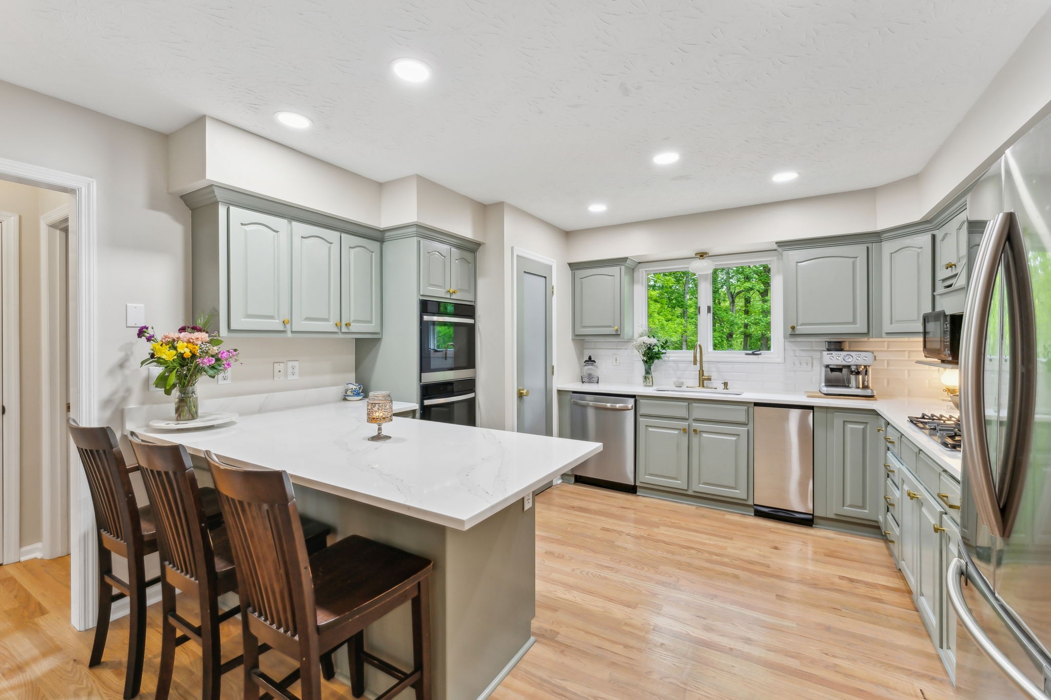 170 Cauble Ridge Lane Manchester, TN 37355 - Photo 23 of 71 a kitchen with stainless steel appliances kitchen island granite countertop a stove refrigerator and white cabinets with wooden floor