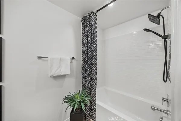 a bathroom with a shower curtain and a bathtub