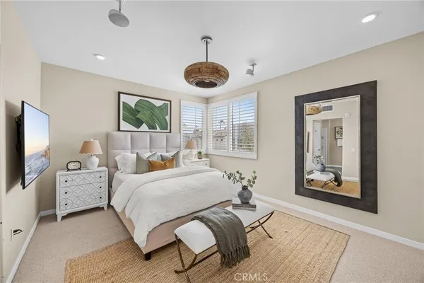 a bedroom with bed and windows