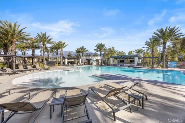 a view of a swimming pool with lounge chairs