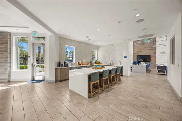 a large white building with kitchen island a large window in it