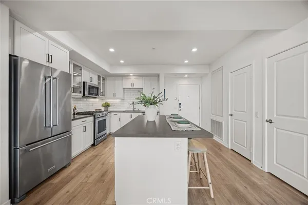 a kitchen with stainless steel appliances a refrigerator sink and stove