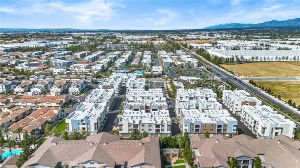 an aerial view of residential houses with city view
