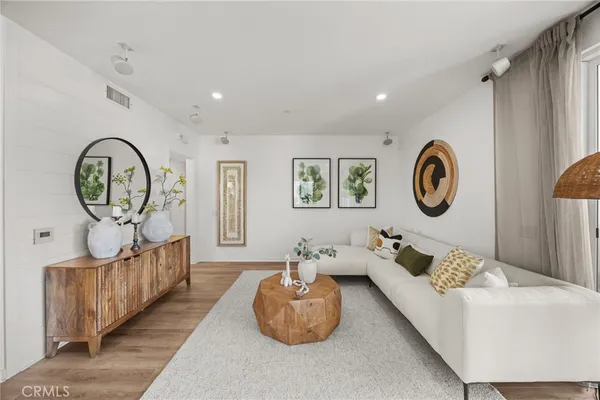 a living room with furniture and a mirror