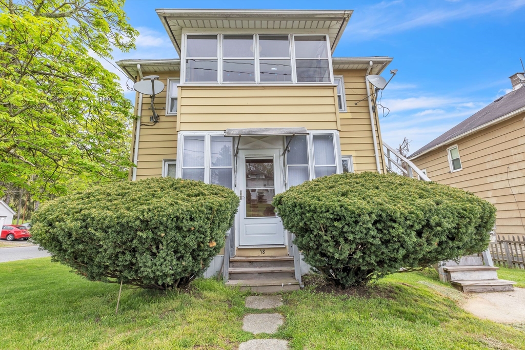 a front view of a house with garden