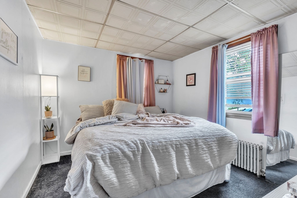 18 Goodwin Street Springfield, MA 01151 - Photo 13 of 31 a bed sitting in a spacious bedroom next to a window