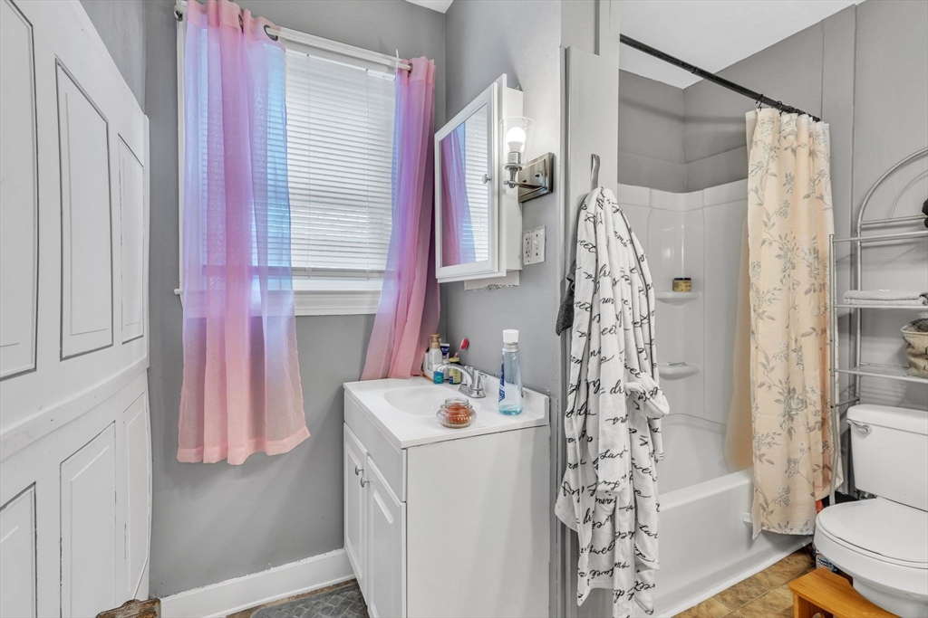 18 Goodwin Street Springfield, MA 01151 - Photo 14 of 31 a bathroom with a sink a toilet and shower curtain