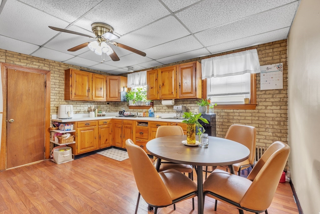 18 Goodwin Street Springfield, MA 01151 - Photo 6 of 31 a kitchen with a dining table chairs stainless steel appliances and cabinets