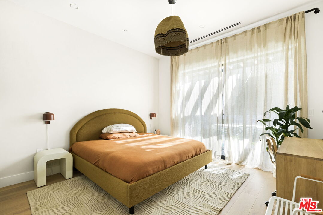 6310 Mirror Lake Drive Los Angeles, CA 90068 - Photo 13 of 34 a bedroom with a bed and a potted plant