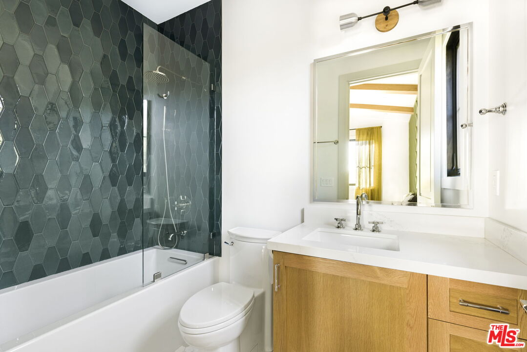 6310 Mirror Lake Drive Los Angeles, CA 90068 - Photo 14 of 34 a bathroom with a bathtub shower sink vanity mirror and toilet