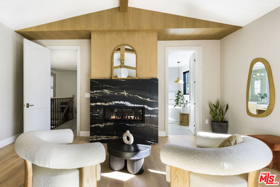 6310 Mirror Lake Drive Los Angeles, CA 90068 - Photo 16 of 34 a living room with fireplace and a table